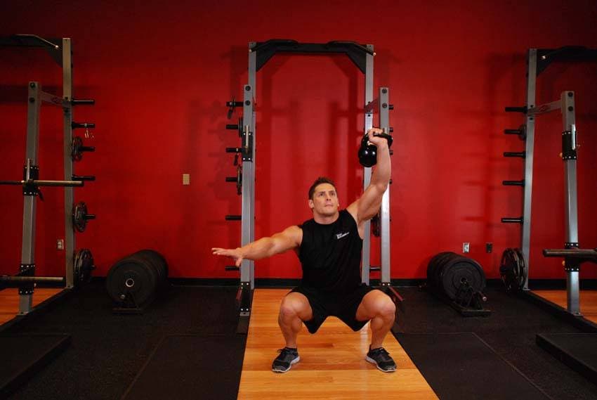 One-Arm Overhead Kettlebell Squats - ending position