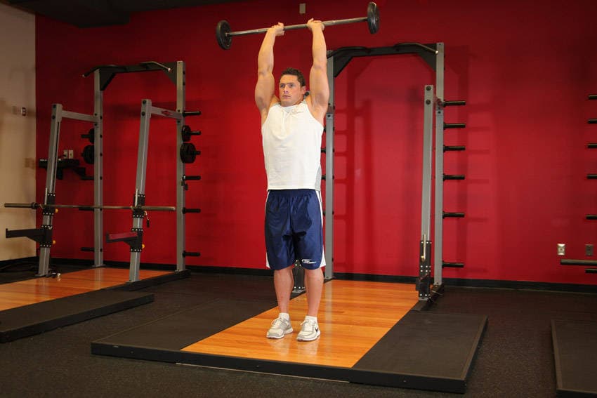 Standing Overhead Barbell Triceps Extension - ending position